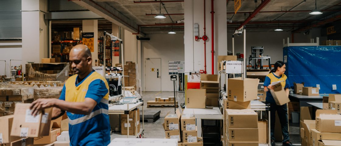 YCH team members packing orders at a warehouse pack station